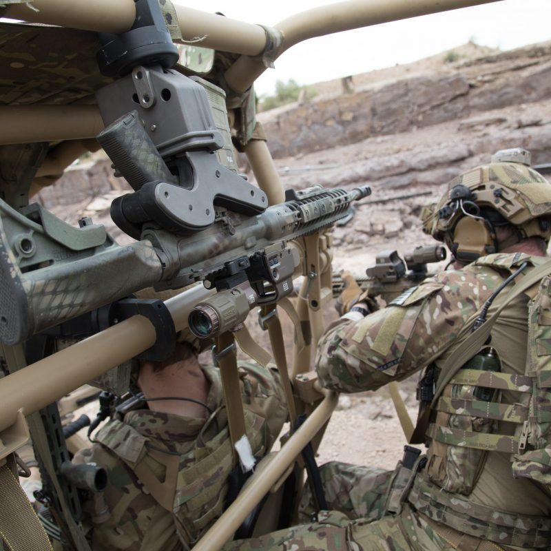 soldiers sighting in a target from utv with a 1082 gun rack mounted overhead holding ar15