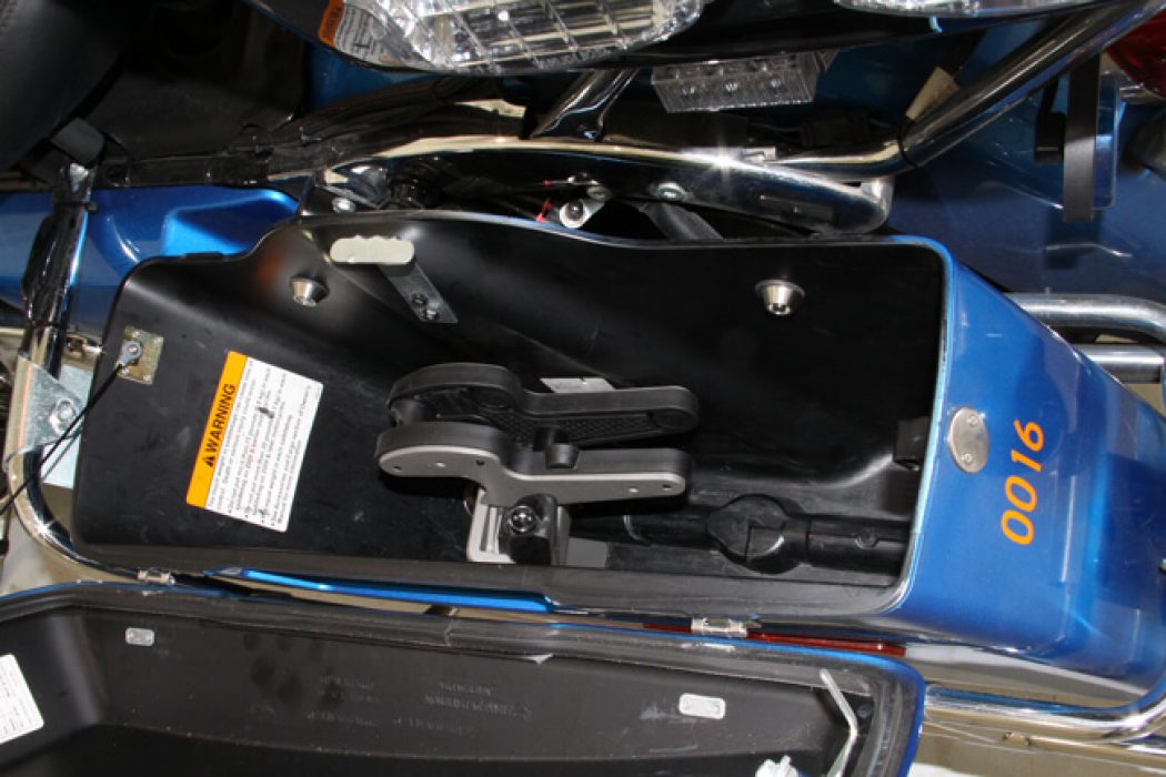 A Blac-Rac 1082 weapon retention system is installed in a Harley Davidson police motorcycle in the left-side saddlebag.