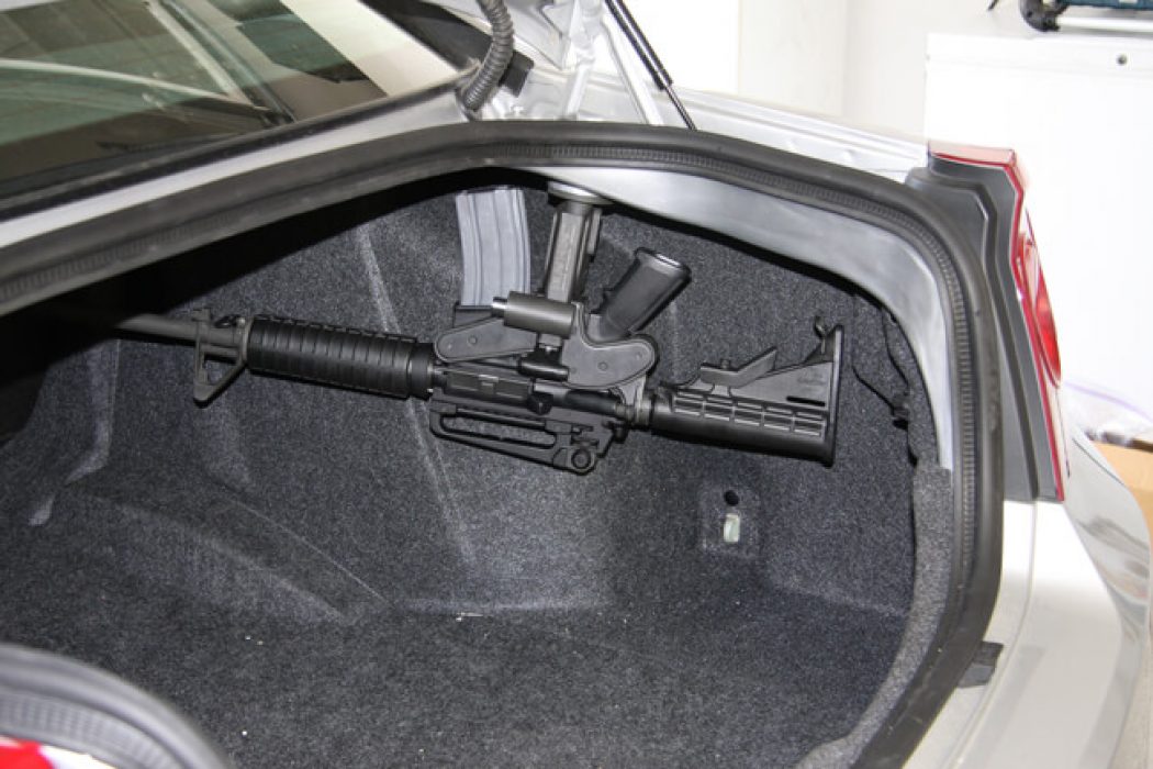 a 1070 is mounted in the trunk of a vehicle protecting an ar15