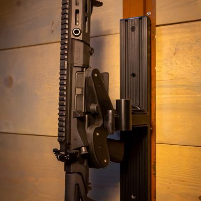 a wall mounted t-channel with a locked 1070 gun rack holding maxim pdx