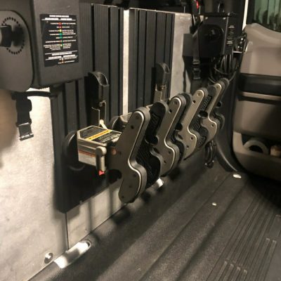 multiple 1082 gun racks mounted in back of truck